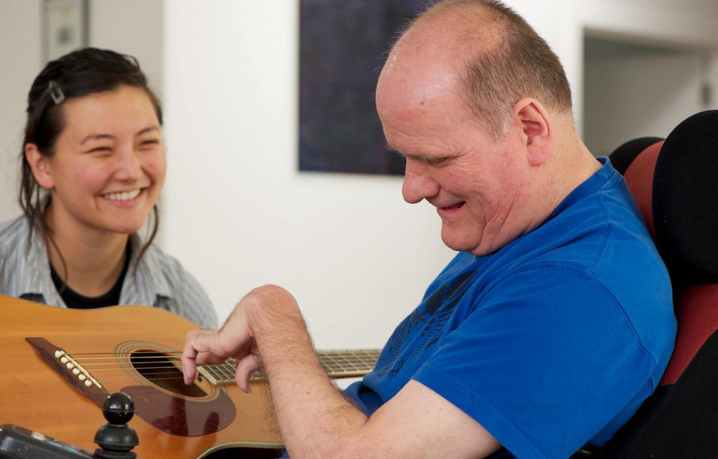 Man with a Disability playing Guitar
