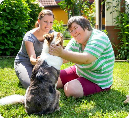 Mentally disabled woman with a second woman and a companion dog
